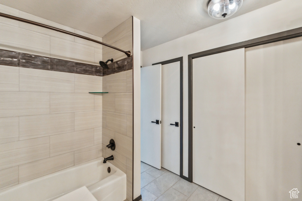 Bathroom with shower / bath combination and tile patterned floors