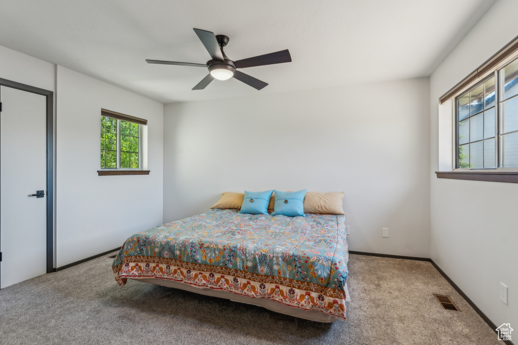 Bedroom with carpet flooring and a ceiling fan