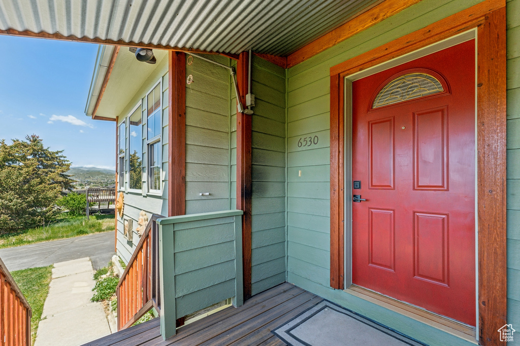 Doorway to property featuring a porch