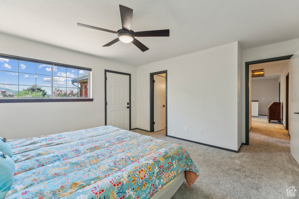 Bedroom featuring light colored carpet and ceiling fan
