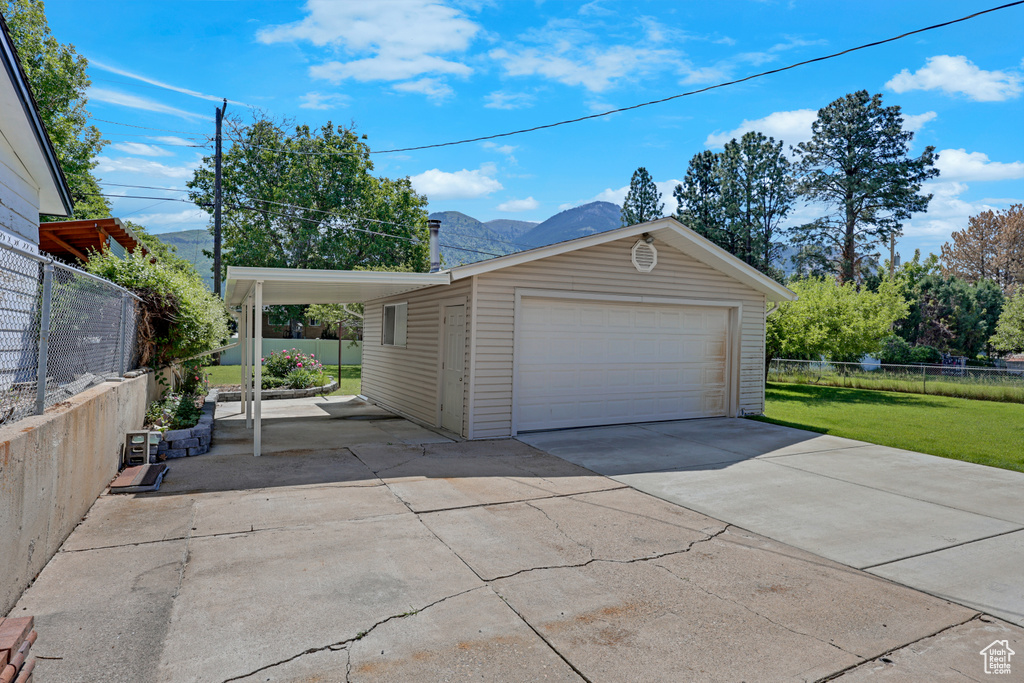 Garage featuring a detached garage and a mountain view