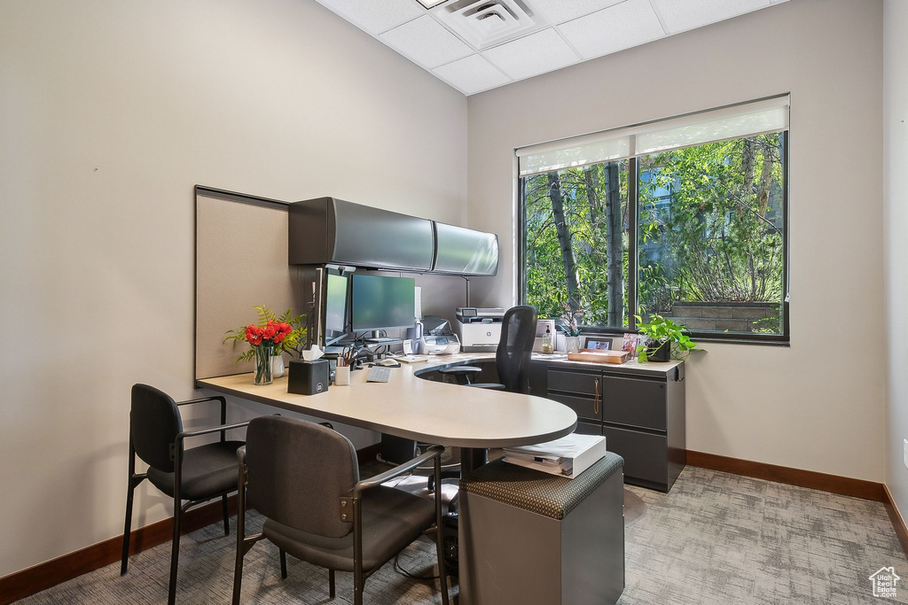 Office area featuring baseboards and a paneled ceiling