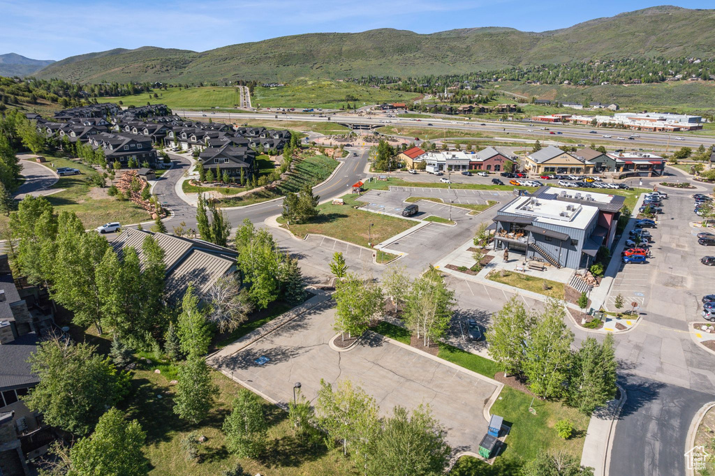 Aerial view of property's location featuring mountains and nearby suburban area