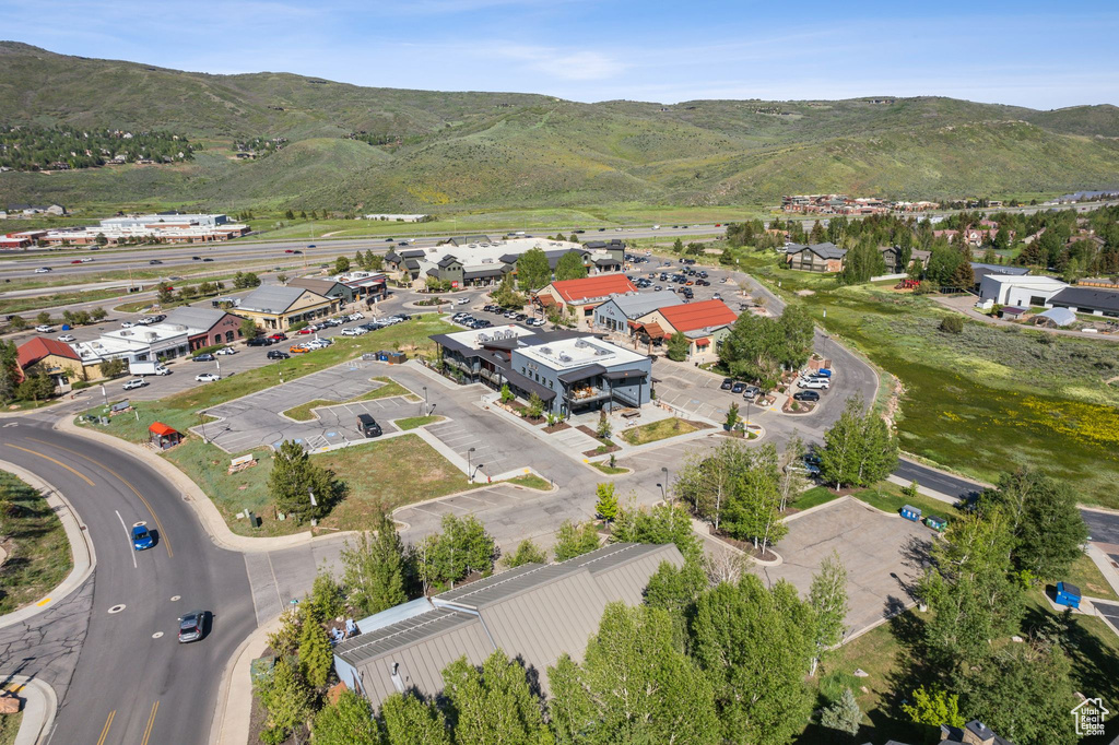 Aerial view of property and surrounding area with a mountain backdrop