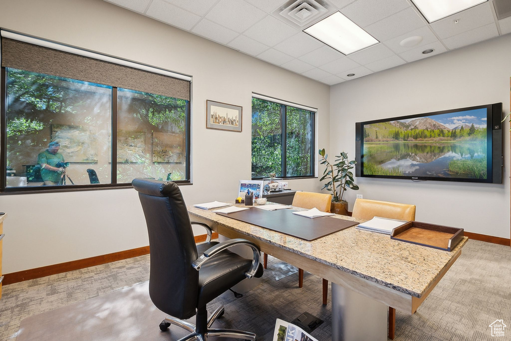 Home office featuring a paneled ceiling and baseboards