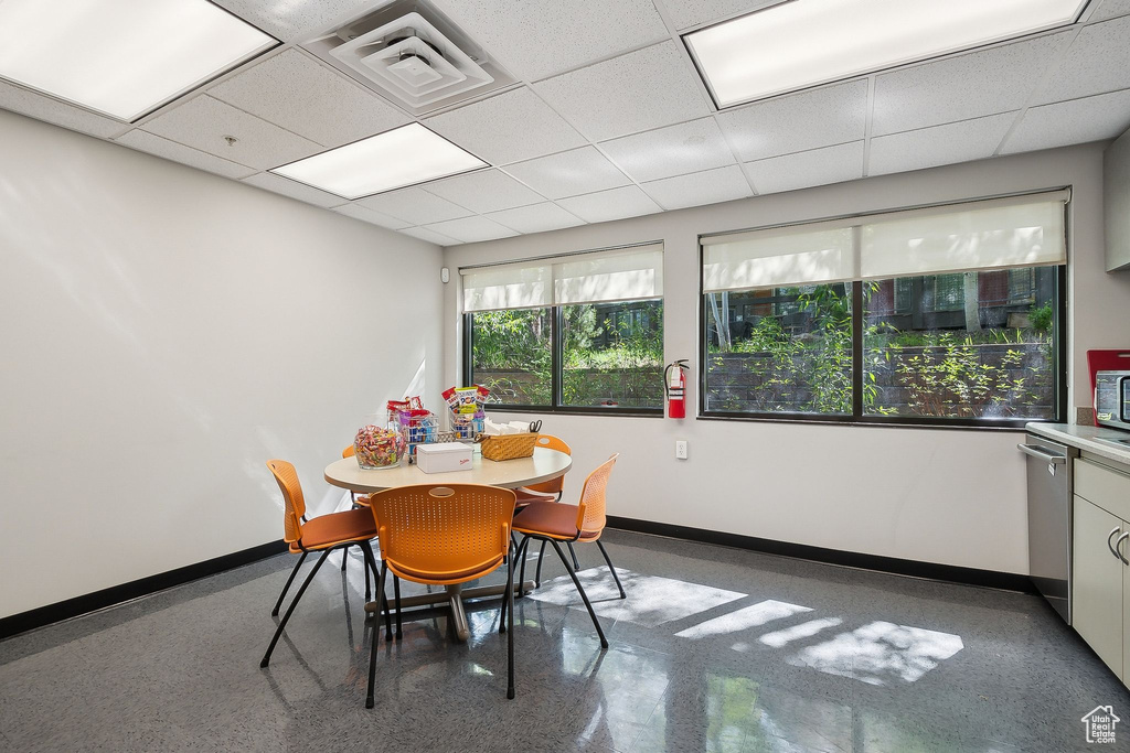 Dining space with baseboards and a paneled ceiling