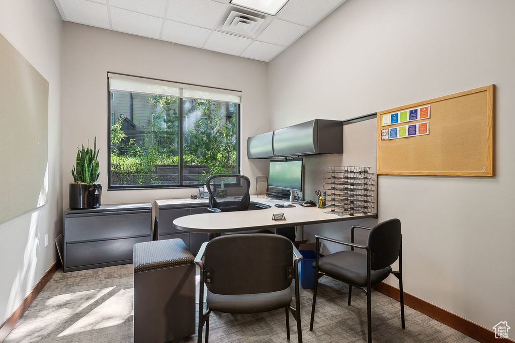 Home office featuring a paneled ceiling and baseboards