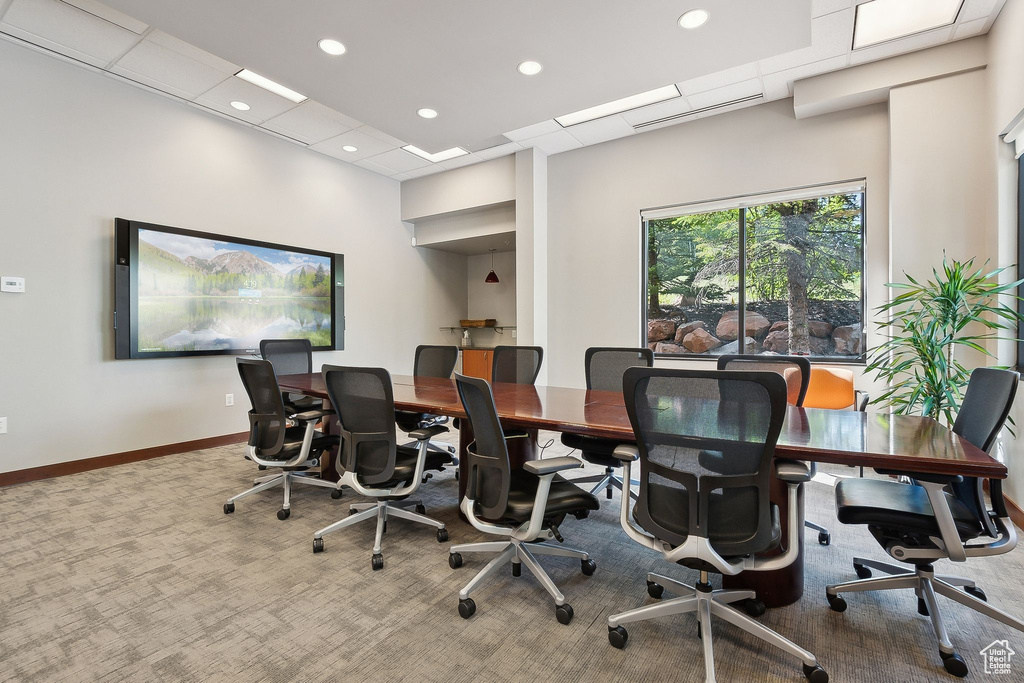 Carpeted office space with baseboards
