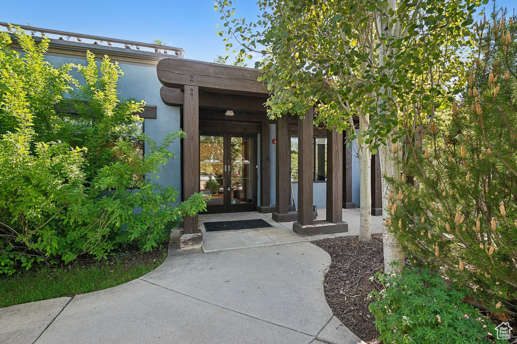Doorway to property with french doors and stucco siding
