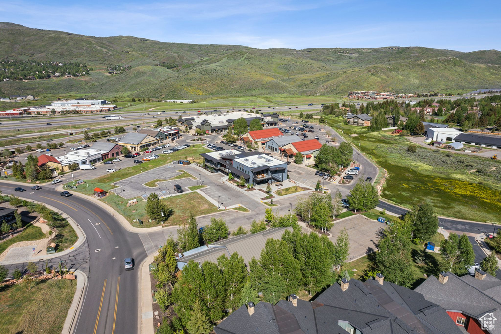 Aerial view of property and surrounding area featuring nearby suburban area and mountains