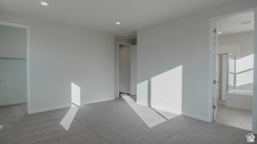 Unfurnished bedroom featuring carpet floors, recessed lighting, baseboards, and connected bathroom