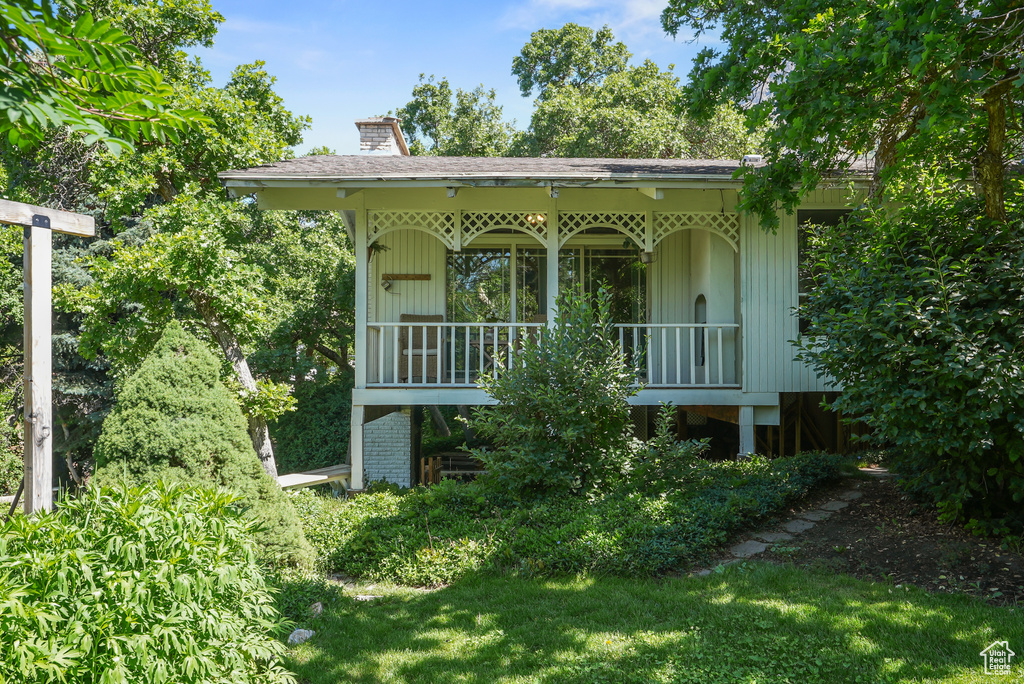 View of front of property with a chimney and a porch