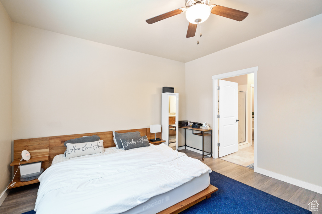 Bedroom featuring wood finished floors, baseboards, and a ceiling fan