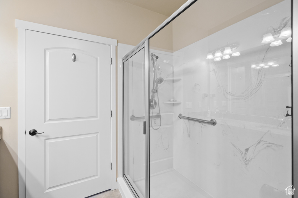 Full bathroom with a marble finish shower