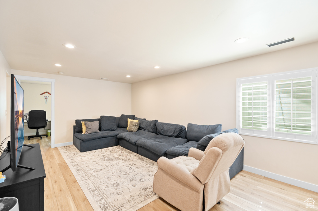 Living area featuring recessed lighting, light wood-style flooring, and baseboards