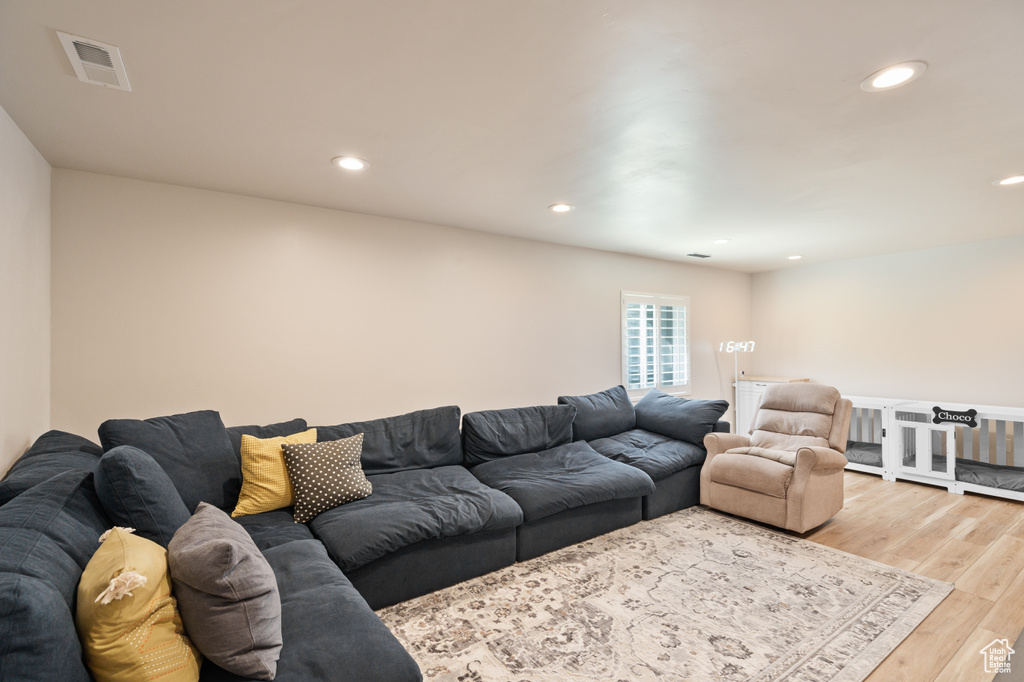 Living room with light wood-style floors and recessed lighting