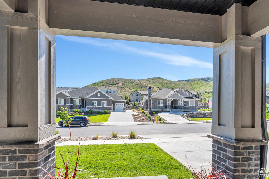 View of yard featuring a residential view, covered porch, and a mountain view