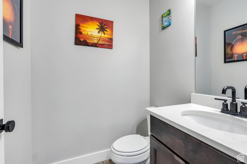 Half bathroom with vanity and toilet