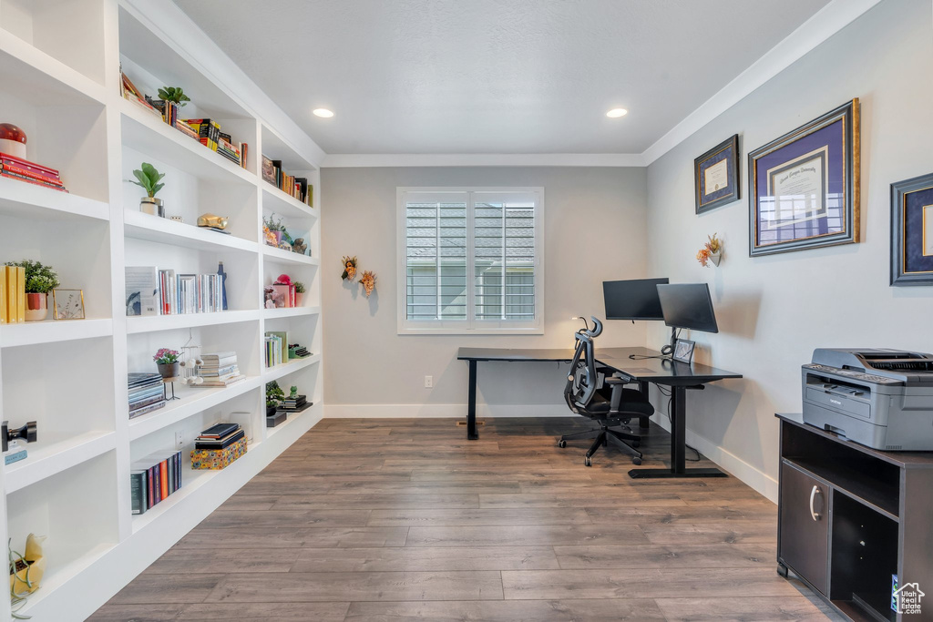 Office with crown molding, wood finished floors, baseboards, and recessed lighting