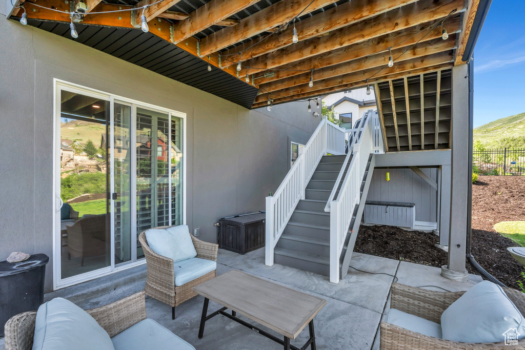 View of patio / terrace with stairs and a mountain view
