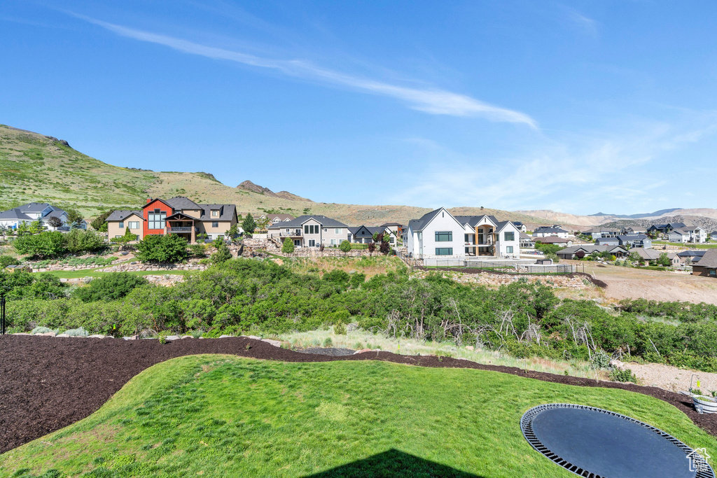 View of green lawn with a mountain view and a residential view