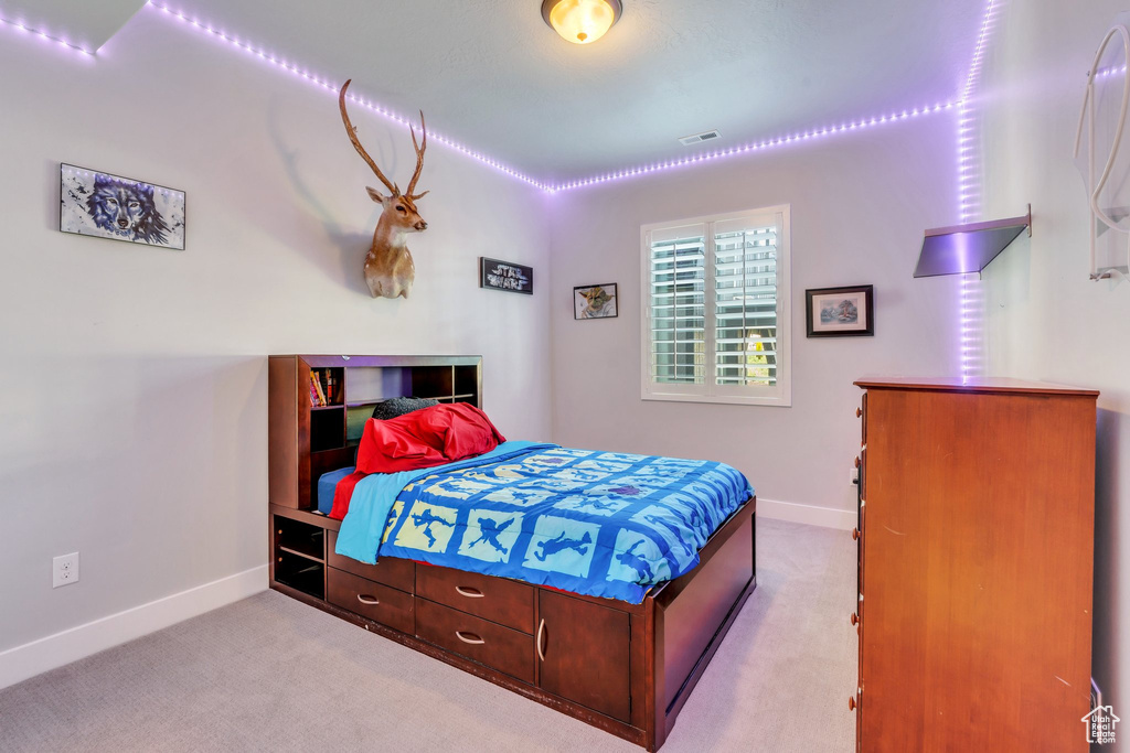 Bedroom with baseboards and carpet