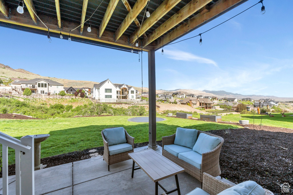 View of patio / terrace with a residential view, a mountain view, and an outdoor living space