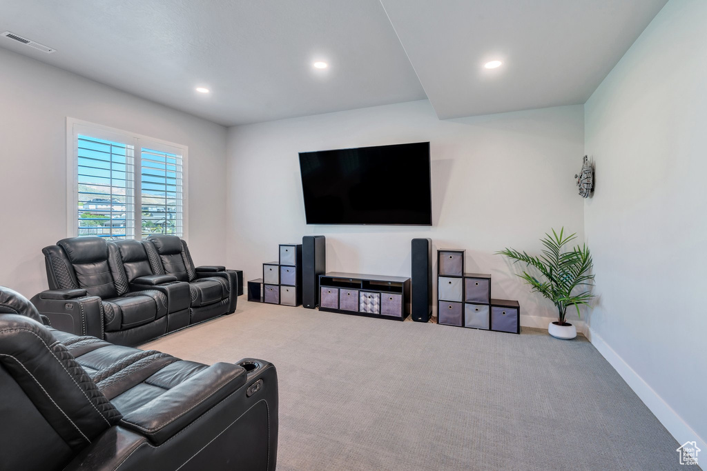 Carpeted living room with recessed lighting and baseboards