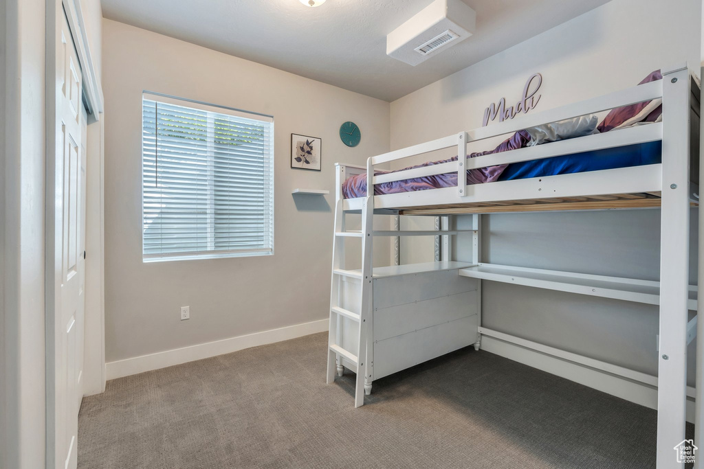 Unfurnished bedroom with carpet floors and baseboards