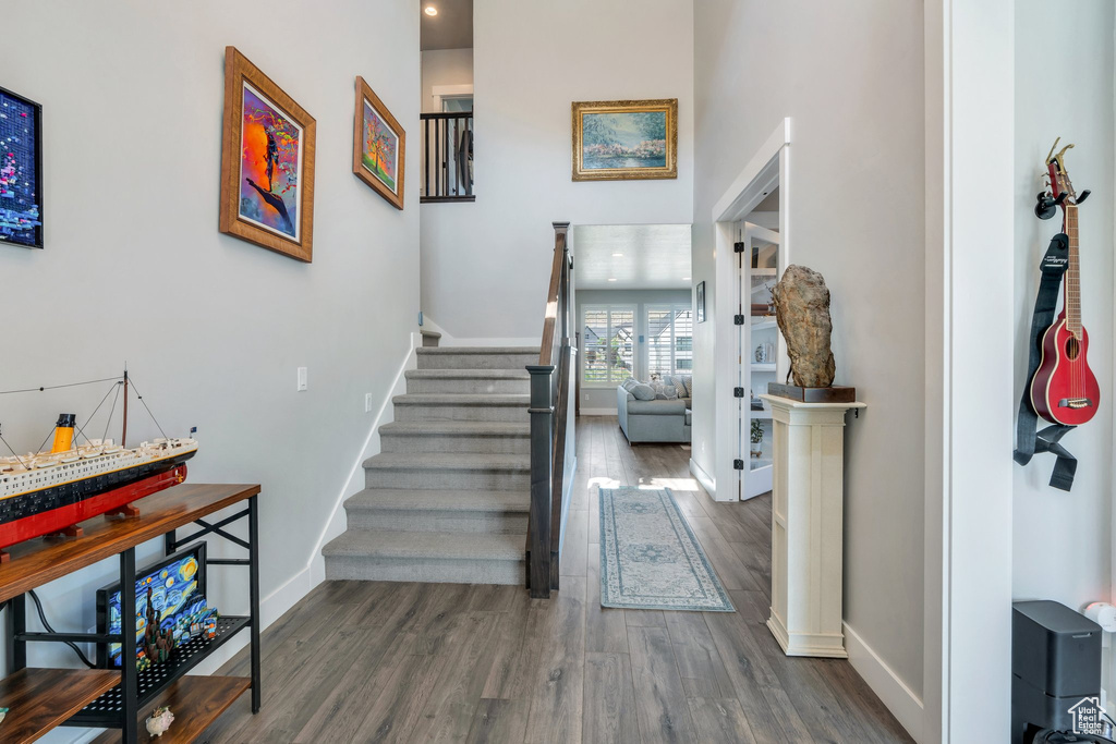 Stairs featuring wood finished floors and baseboards