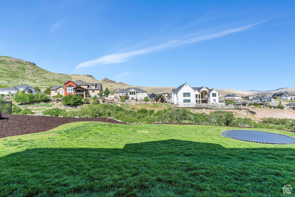 View of grassy yard with a mountain view and a residential view