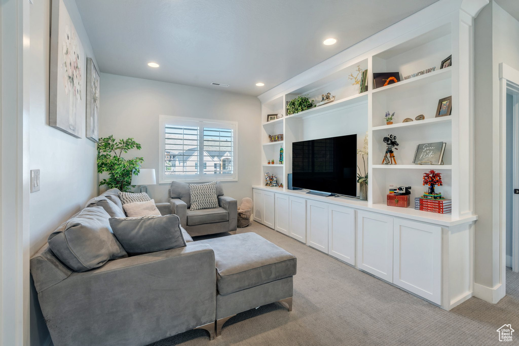 Living area featuring recessed lighting and light carpet