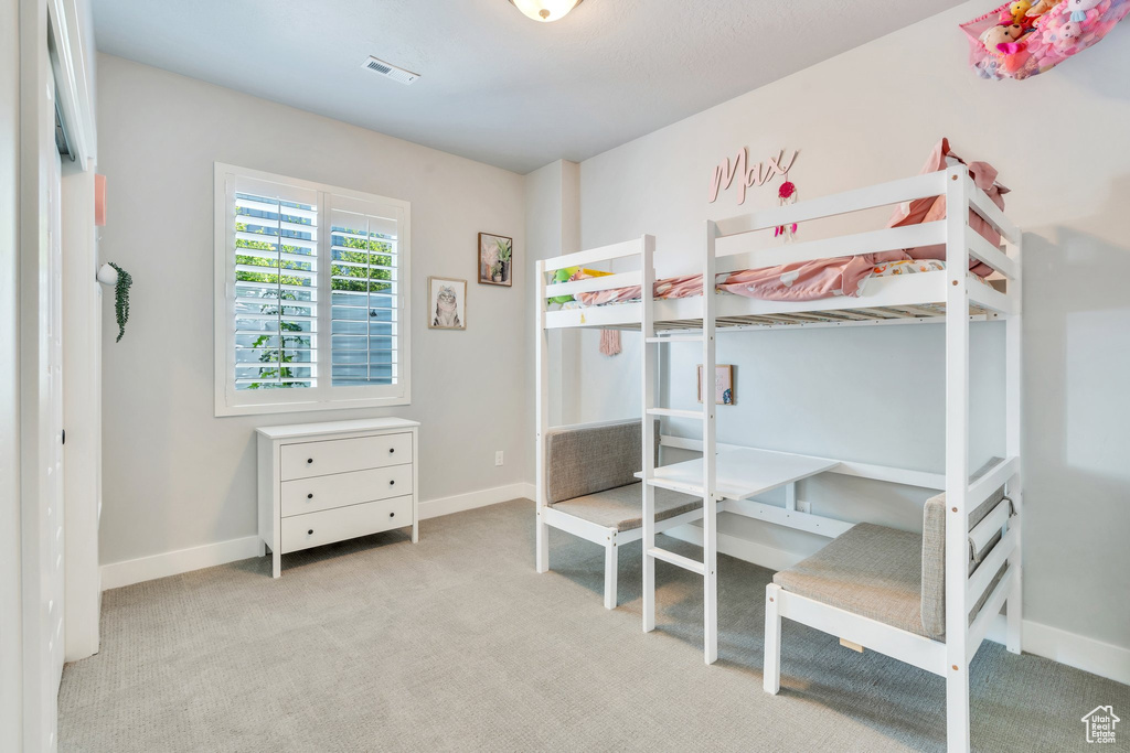 Carpeted bedroom with baseboards