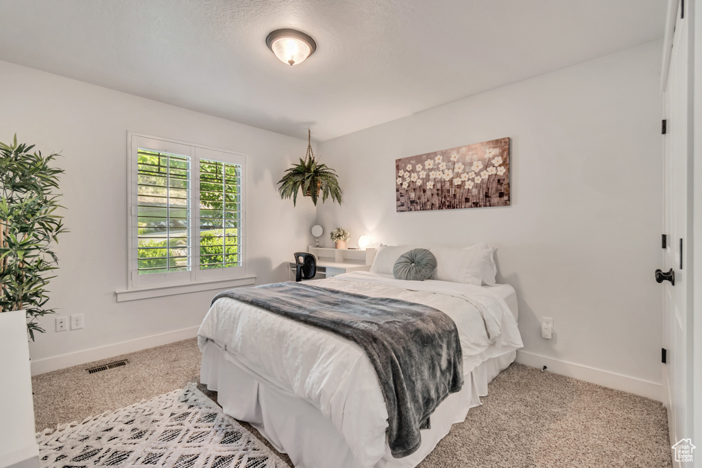 Bedroom featuring baseboards and carpet