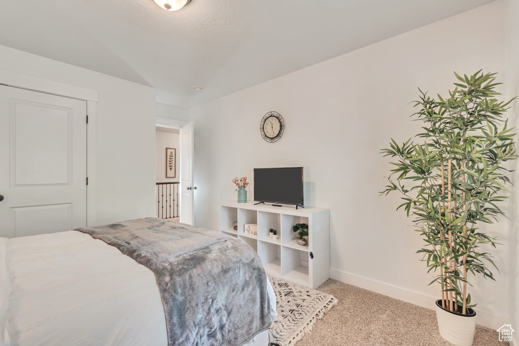 Carpeted bedroom with baseboards