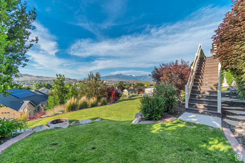 View of green lawn with stairway, a mountain view, and a residential view