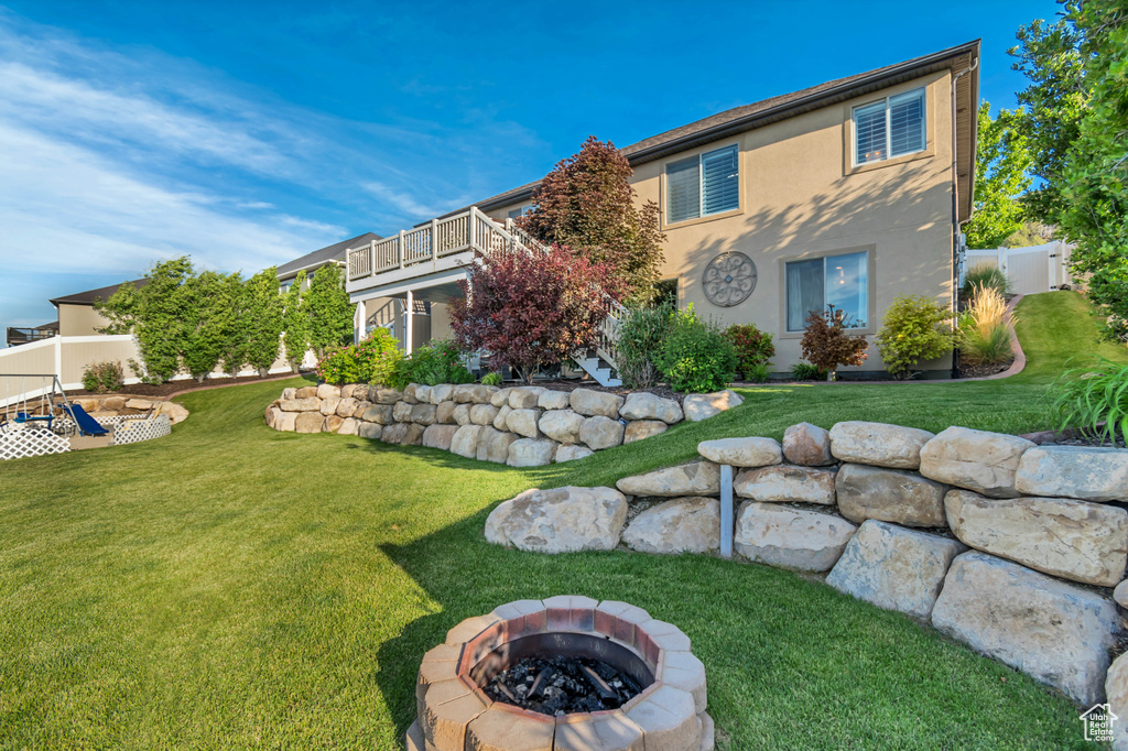 View of yard featuring a fire pit and a wooden deck