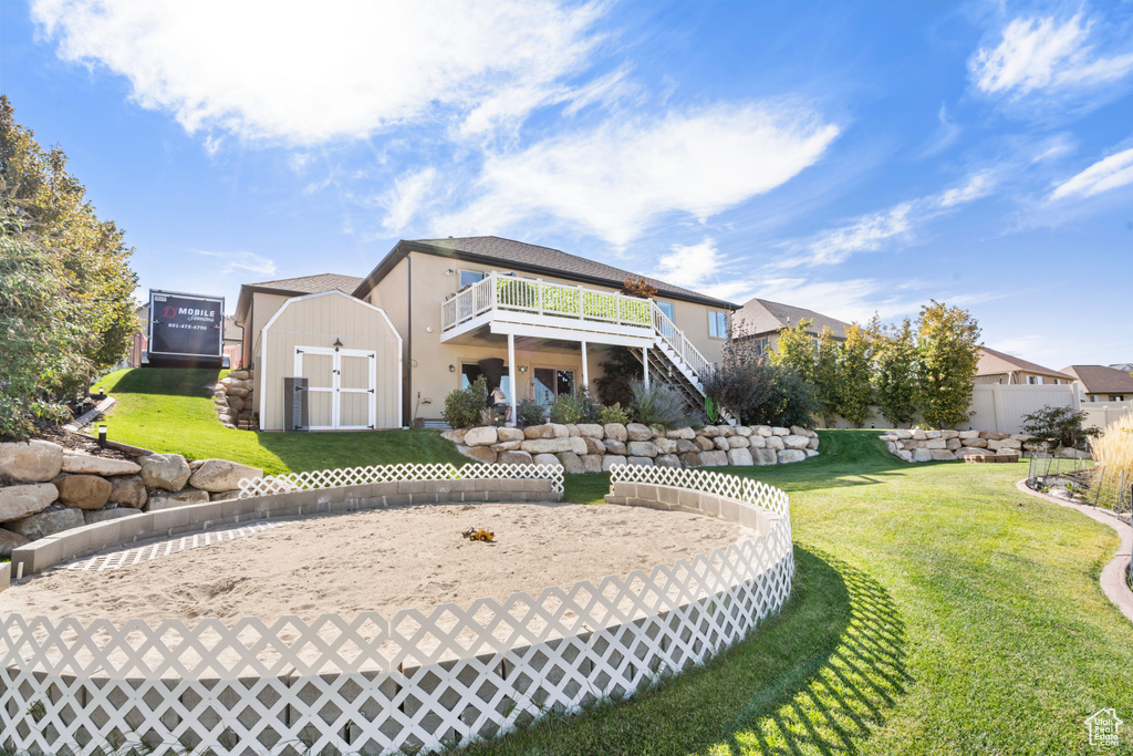 Rear view of house with stairs, stucco siding, and a deck