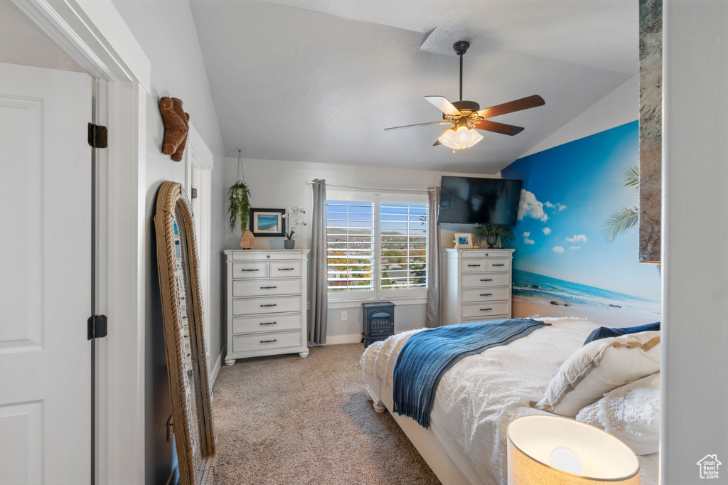 Carpeted bedroom with lofted ceiling, ceiling fan, and baseboards