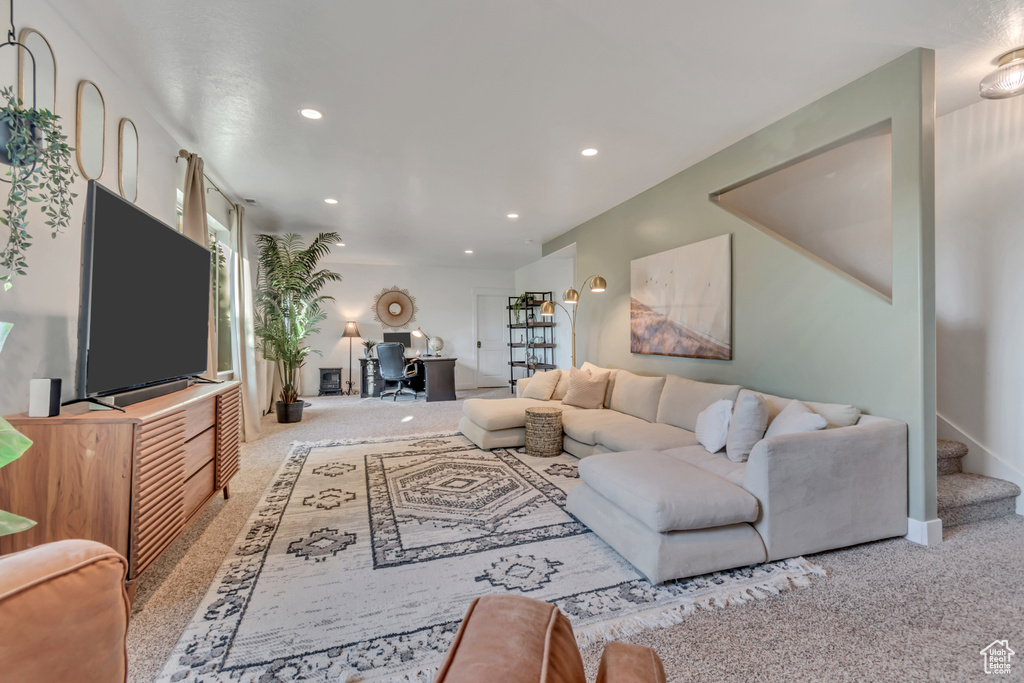 Living area with carpet flooring, an office area, recessed lighting, and stairway