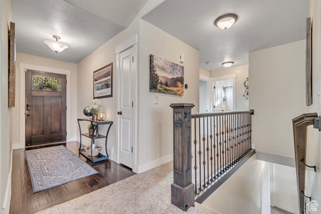 Entrance foyer featuring wood finished floors and baseboards