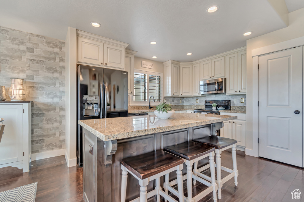 Kitchen featuring stainless steel microwave, baseboards, dark wood-type flooring, recessed lighting, and fridge with ice dispenser