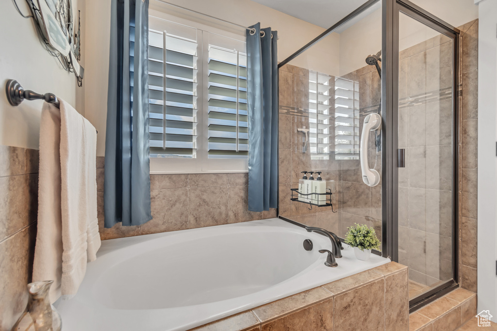 Bathroom featuring a shower stall and a garden tub