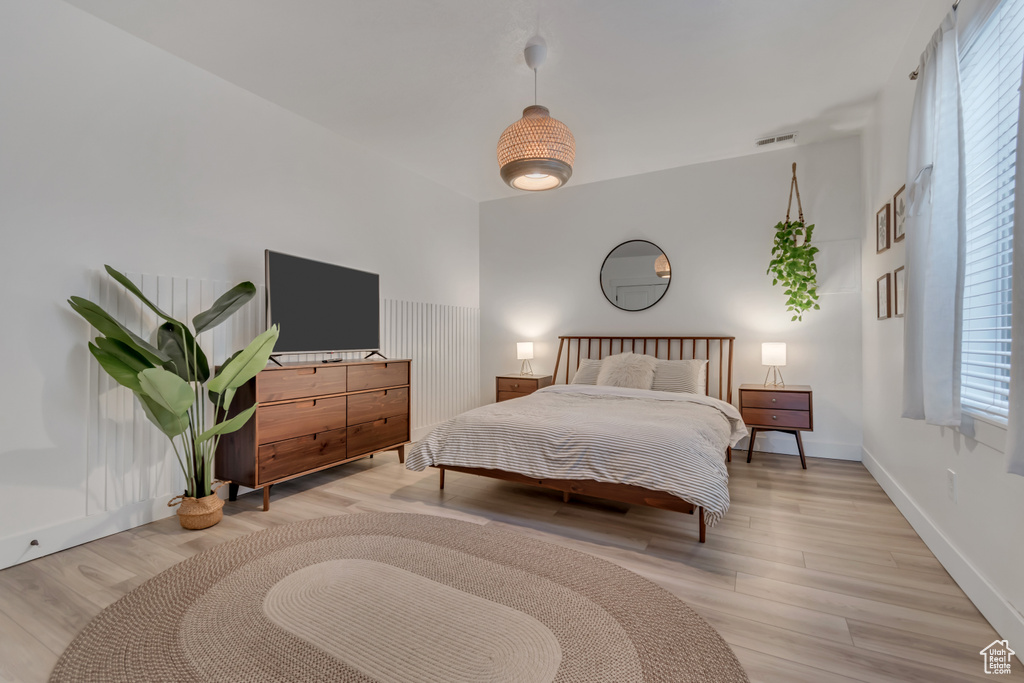 Bedroom with light wood-style flooring and baseboards