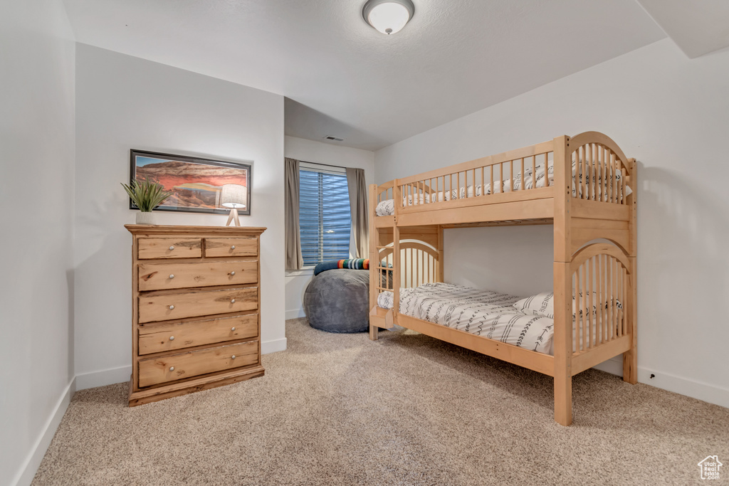 Carpeted bedroom featuring baseboards