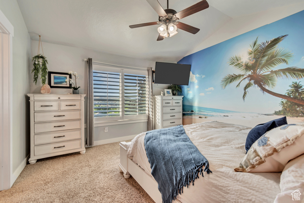 Bedroom with baseboards, carpet, lofted ceiling, and a ceiling fan