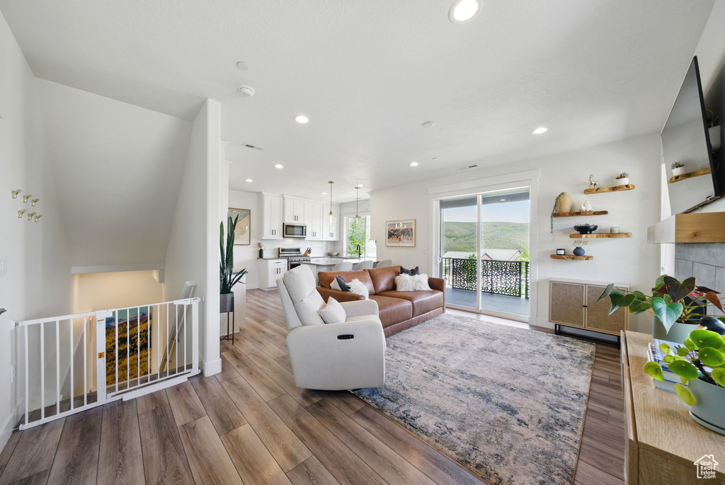 Living room featuring wood finished floors and recessed lighting