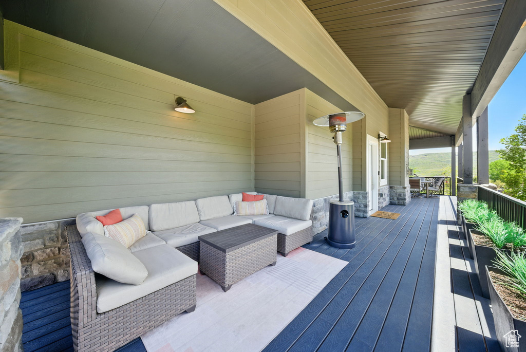 Wooden porch featuring outdoor lounge area
