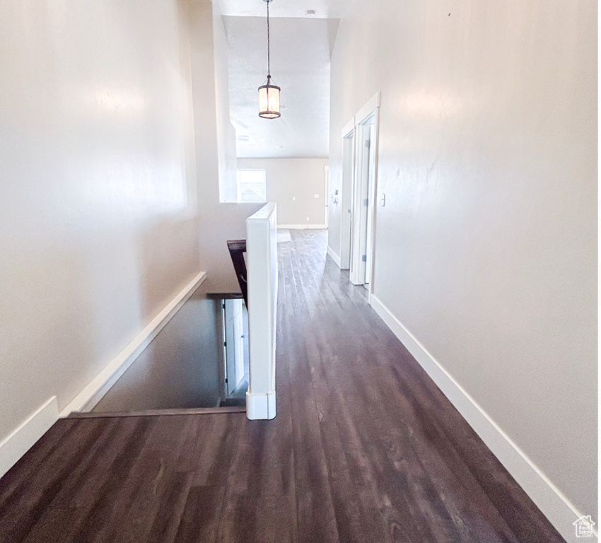 Corridor with dark wood finished floors and baseboards