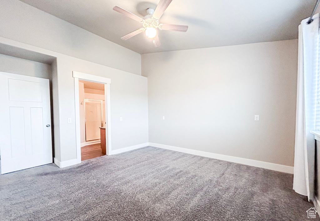 Unfurnished bedroom with carpet floors, baseboards, and a ceiling fan